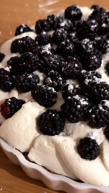 Key Lime Cheesecake with White Chocolate Whipped Cream. Topped with Blackberries and powdered sugar.
 ❤️

A simple, no-bake key lime pie / cheesecake hybrid with a graham cracker crust that you can make easily and quickly at home. Topped with fresh white chocolate whipped cream and blackberries, you just can’t stop at one piece…

Key Lime Cheesecake
14 oz Sweetened Condensed Milk
8 oz Cream Cheese, Softened
1/2 Cup Key Lime Juice
1/2 teaspoon Vanilla Extract
1 Large Container of Blackberries, Washed
9 in Graham Cracker Pie Crust
 - this can be from the store or homemade
Whipped Cream
 -this can be from the store or for the White Chocolate version, see below

1. Blend milk, cream cheese, key lime juice, and vanilla until smooth. 
2. Place in pie crust and refrigerate at least 8 hours. 
3. Top with whipped cream, berries, and powdered sugar.

White Chocolate Whipped Cream
600 g Heavy Whipping Cream
20 mL Whole Milk
10 g Whole Milk Powder
60 g Ghirardelli White Baking Chocolate

1. Melt the white chocolate in a small sauce pot on the lowest setting so you don’t burn the chocolate.
2. When it is smooth, mix in the whole milk until smooth. Add the milk powder and stir until well mixed and smooth. 
3. Whip the whipping cream until it is thickened but not whipped yet; you’ll see peaks but they’ll fall over. Whip until you see the traditional stiff peaks. It will be pipe-able and hold its shape. 
 
Shoutout to yuvrajdewan for the info on stabilizing whipped cream! It is absolutely fabulous, thank you 🙏 
#keylime #instafood #dessert #homemade #brunch